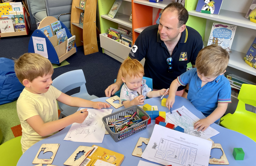 Greg Smith MP with his three sons in Haddenham Library