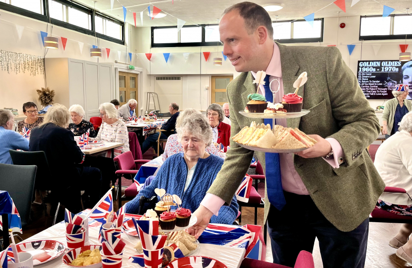 Greg helps out at over 65s Coronation tea at the Princes Centre