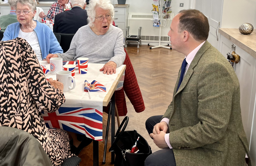 Greg helps out at over 65s Coronation tea at the Princes Centre