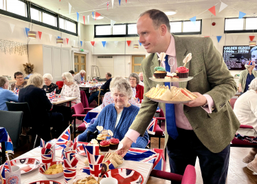 Greg helps out at over 65s Coronation tea at the Princes Centre